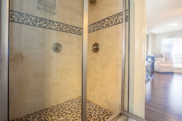 bathroom with walk in shower and hardwood / wood-style floors