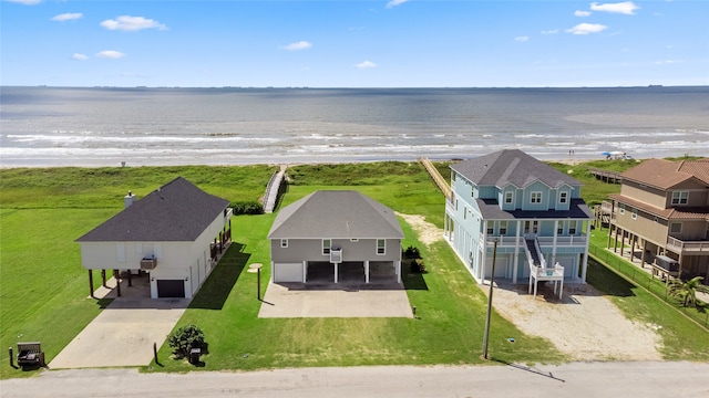 birds eye view of property with a beach view and a water view