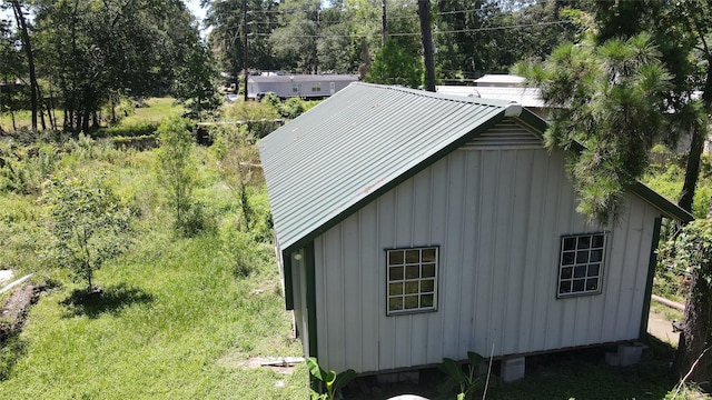 view of side of home with metal roof and board and batten siding