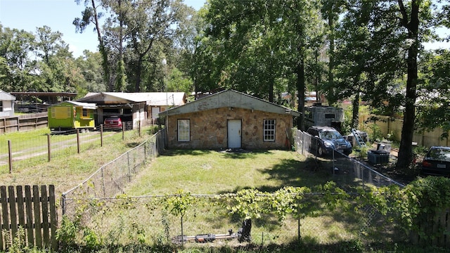 view of front facade with driveway, stone siding, a front lawn, and a carport