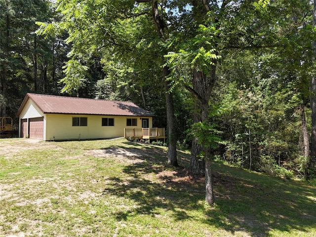 view of yard featuring an outdoor structure and a deck