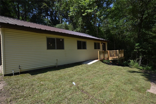 view of side of property featuring a yard and a deck