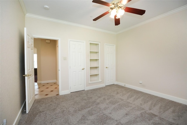 unfurnished bedroom with carpet, crown molding, and ceiling fan