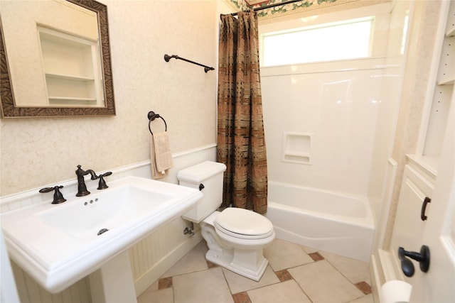 full bathroom featuring tile patterned flooring, shower / bath combo, toilet, and sink