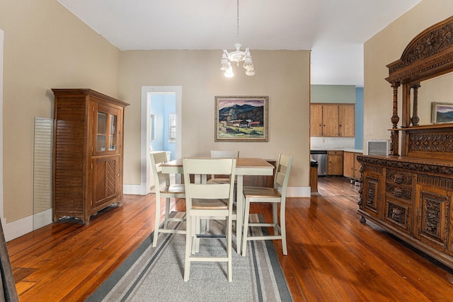 dining room featuring dark hardwood / wood-style flooring and a chandelier