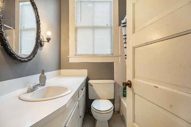 full bathroom featuring tile patterned floors, vanity, toilet, and shower / washtub combination