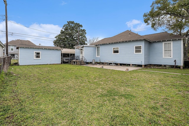 back of house featuring a lawn and a patio