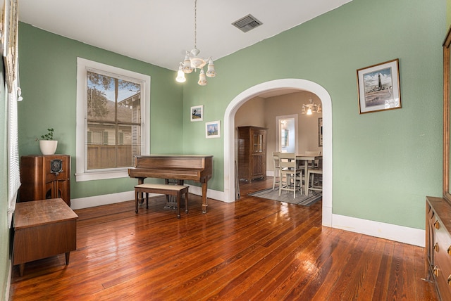 interior space with plenty of natural light, dark hardwood / wood-style floors, and a notable chandelier