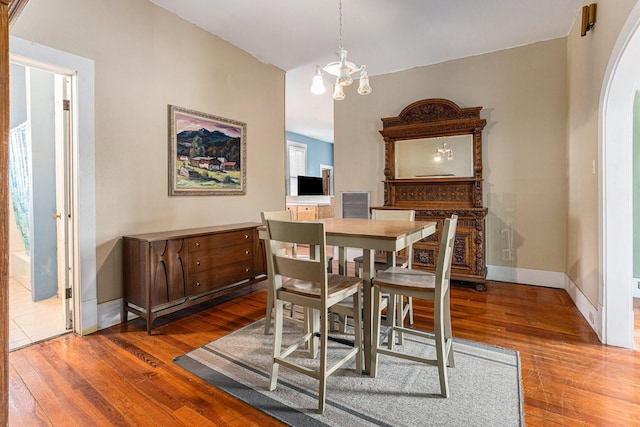 dining room with a notable chandelier and dark hardwood / wood-style floors