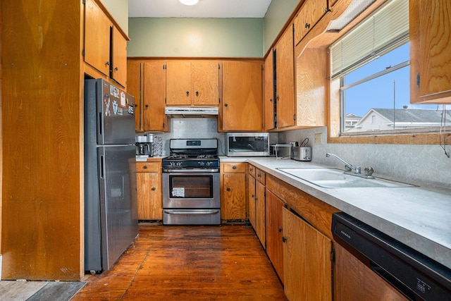 kitchen featuring backsplash, sink, dark hardwood / wood-style floors, and appliances with stainless steel finishes