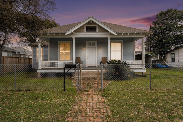 bungalow-style home featuring a lawn and a porch