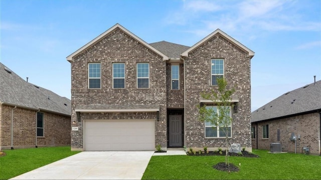 view of front of home with a garage and a front lawn