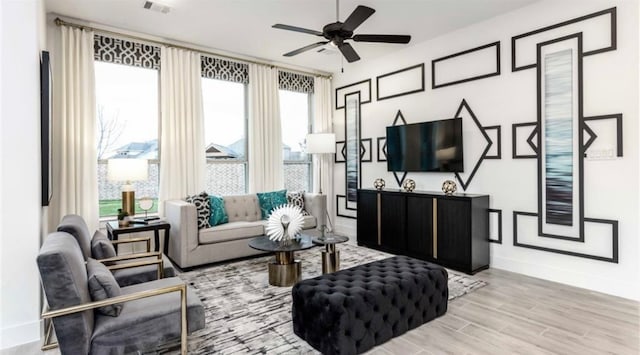 living room with ceiling fan and light wood-type flooring