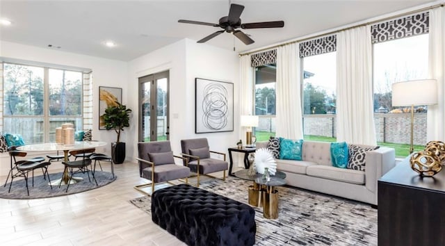 living room featuring ceiling fan, a healthy amount of sunlight, and light hardwood / wood-style flooring