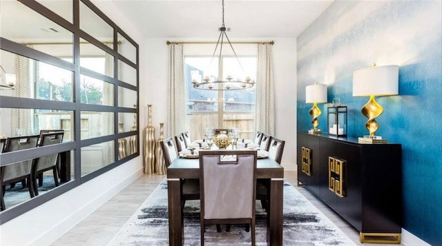 dining room with a notable chandelier and hardwood / wood-style floors