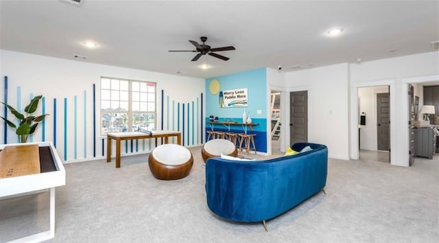 living room with ceiling fan and carpet floors