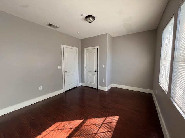 unfurnished room featuring dark hardwood / wood-style flooring