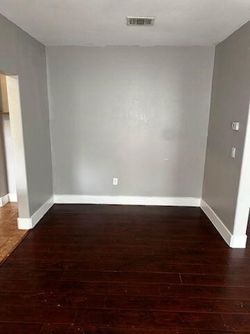 unfurnished room featuring dark hardwood / wood-style flooring