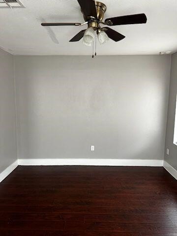 unfurnished room featuring dark hardwood / wood-style floors and ceiling fan