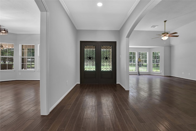 foyer entrance with plenty of natural light, ornamental molding, and dark wood-type flooring