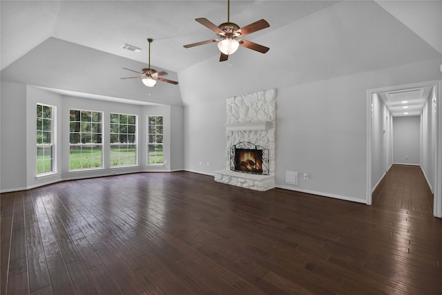 unfurnished living room with ceiling fan, a stone fireplace, dark wood-type flooring, and high vaulted ceiling