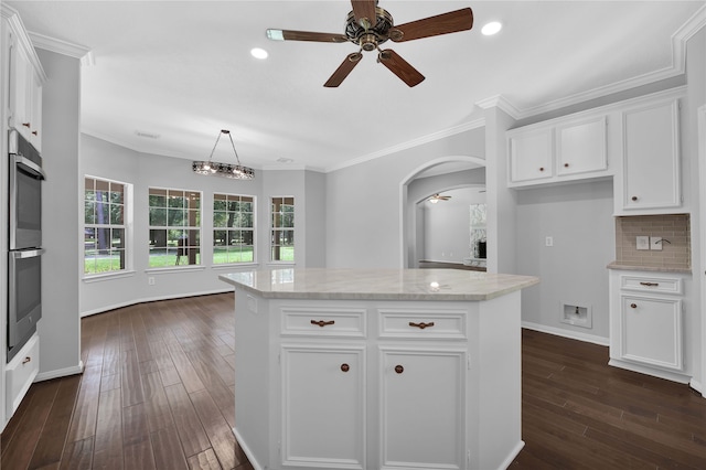 kitchen featuring white cabinets, dark hardwood / wood-style floors, and a kitchen island