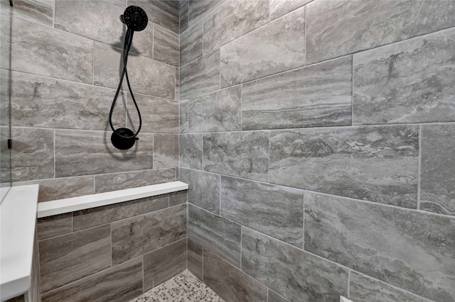 bathroom with tiled shower