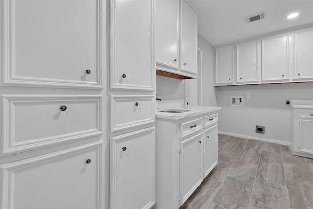 laundry area featuring hookup for an electric dryer, cabinets, sink, and hookup for a washing machine