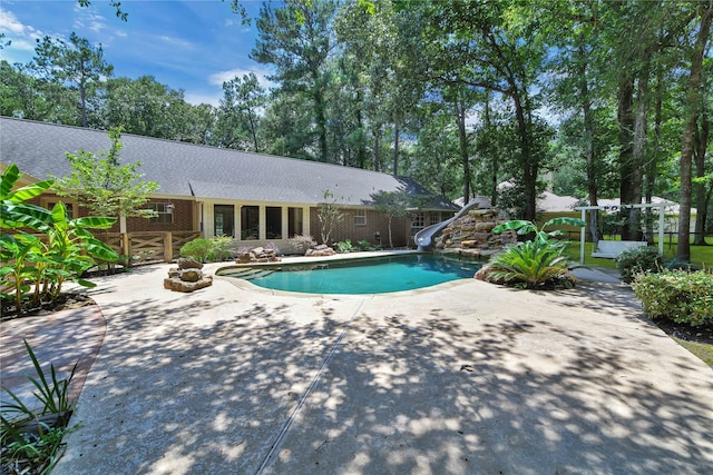 view of swimming pool featuring a patio area and a water slide