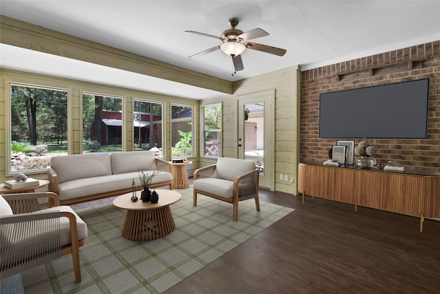 living room featuring dark hardwood / wood-style floors, ceiling fan, and wood walls