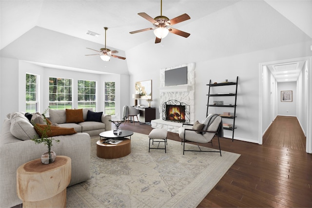 living room featuring dark hardwood / wood-style floors, high vaulted ceiling, and ceiling fan