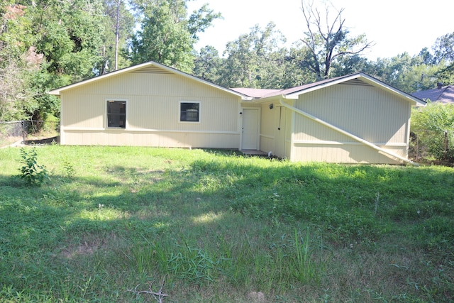 back of property featuring a lawn