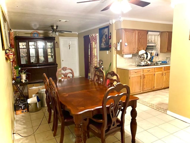 dining area featuring sink, ornamental molding, light tile flooring, and ceiling fan