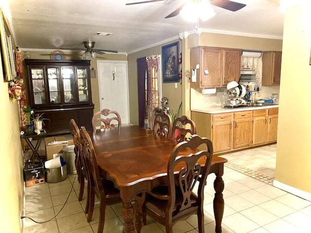 dining space featuring light tile patterned floors, ceiling fan, and ornamental molding