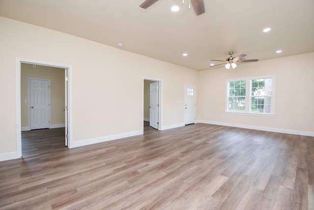 spare room featuring light hardwood / wood-style flooring and ceiling fan