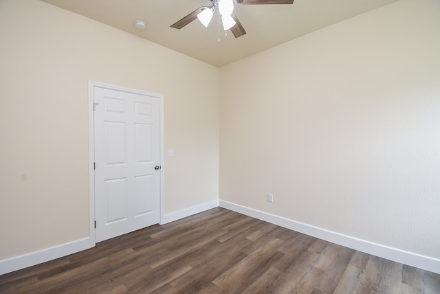 empty room with dark hardwood / wood-style floors and ceiling fan