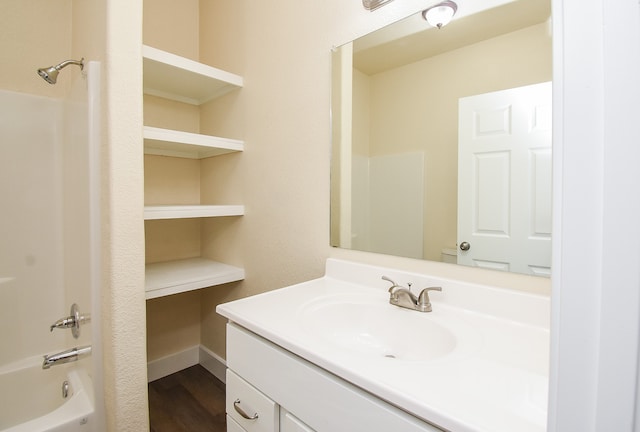 bathroom with vanity, hardwood / wood-style floors, and shower / bathing tub combination