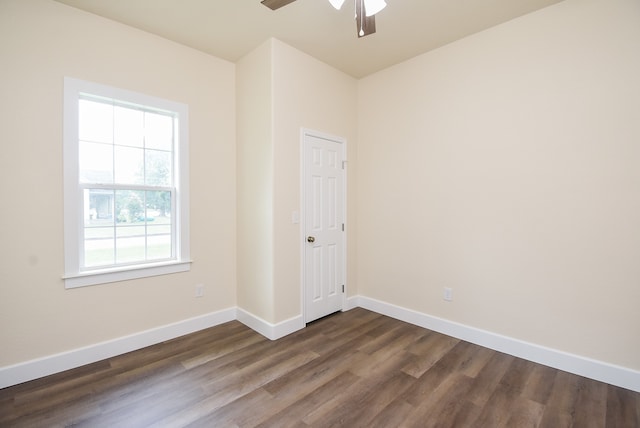 empty room featuring dark hardwood / wood-style flooring and ceiling fan