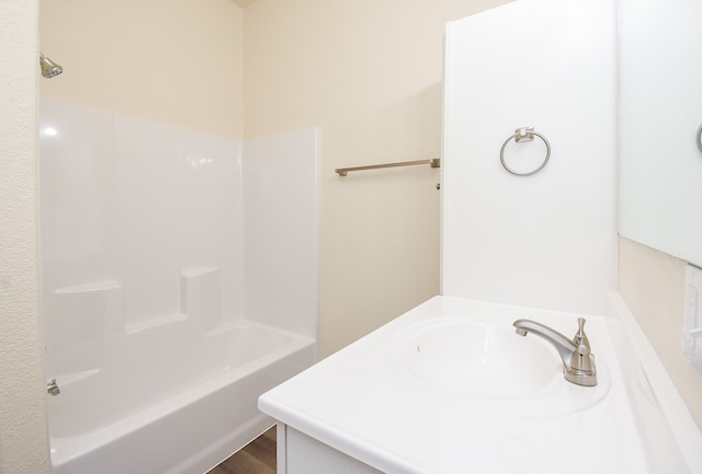 bathroom with hardwood / wood-style floors, vanity, and shower / bathing tub combination