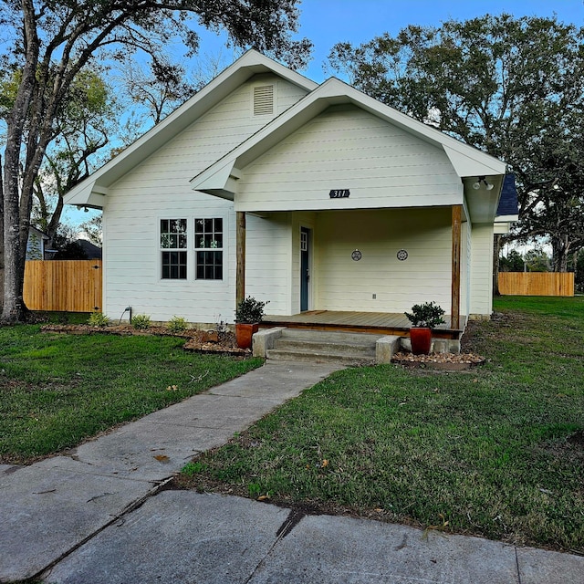 view of front of house with a porch and a front yard