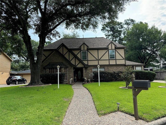 english style home with a front lawn