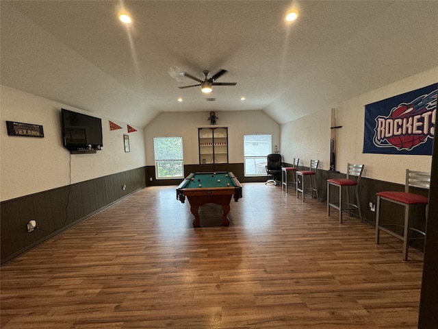 game room featuring ceiling fan, billiards, wood-type flooring, vaulted ceiling, and a textured ceiling