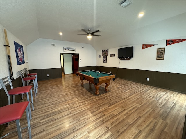 rec room featuring light hardwood / wood-style floors, vaulted ceiling, a textured ceiling, billiards, and ceiling fan