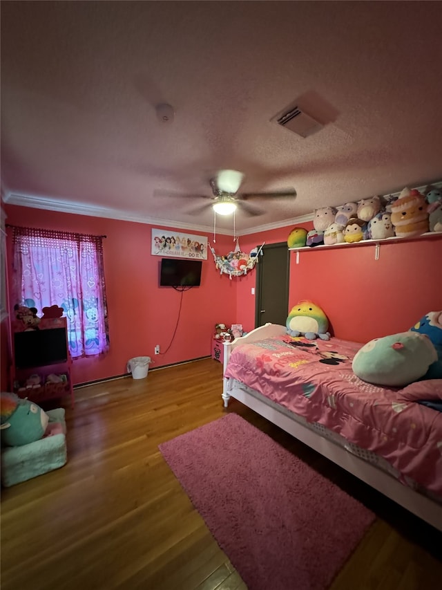 bedroom with ceiling fan, hardwood / wood-style floors, and ornamental molding