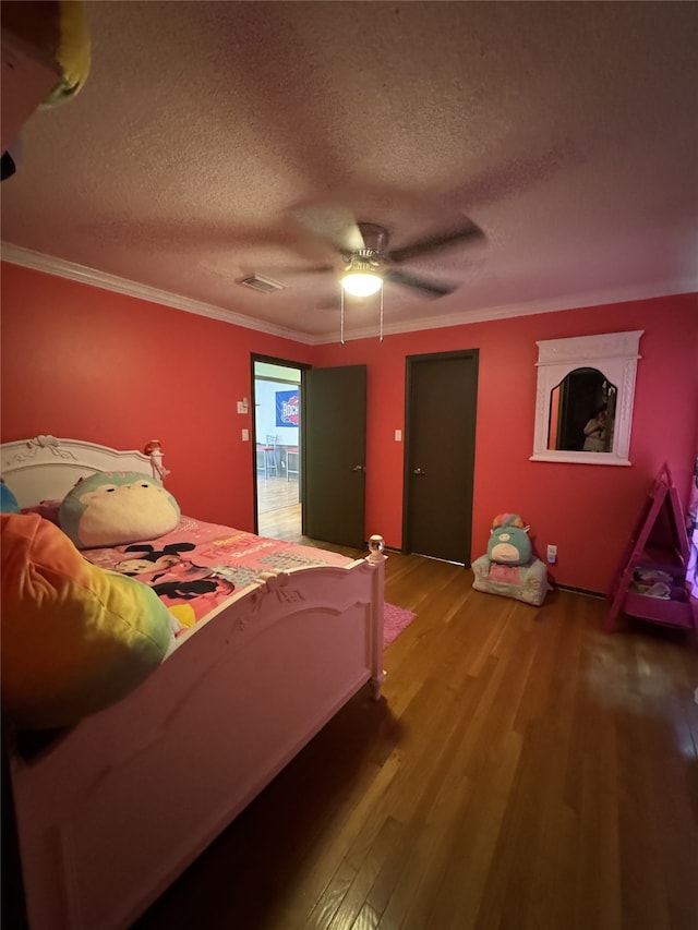 bedroom featuring ceiling fan, hardwood / wood-style flooring, crown molding, and a textured ceiling