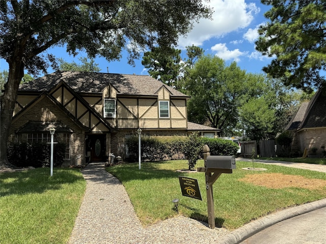 english style home with a front lawn