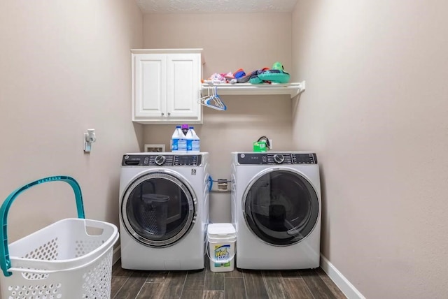 clothes washing area featuring cabinet space, baseboards, wood finish floors, and independent washer and dryer