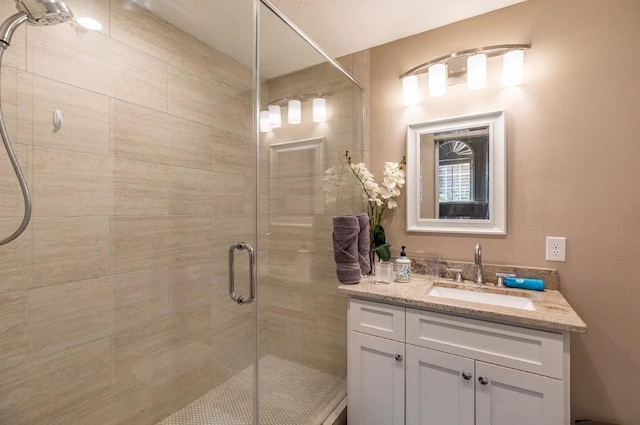 bathroom featuring a shower stall and vanity