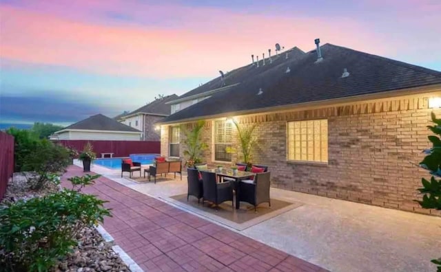 exterior space with an outdoor living space, outdoor dining space, a fenced backyard, and a fenced in pool