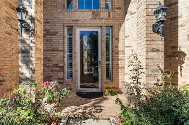 property entrance featuring brick siding